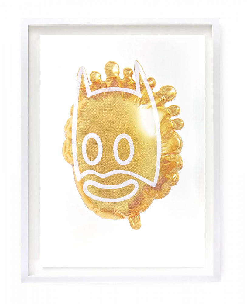 image of metallic gold helium balloon in the shape of a cartoon Queen Elizabeth II figure with superimposed Batman mask.
